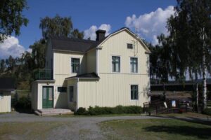 The hostel house under a blue sky with white clouds