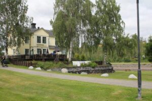 Strömsborg seen from the park’s gravel path, with birches and the river to the right